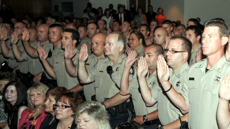 St. Bernard Parish sheriffs deputies take their oath of office. Photo by Errol Schultz.