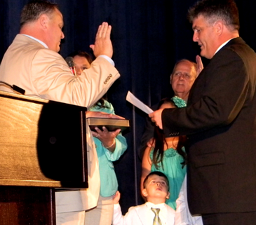 New Clerk of Court Randy Nunez, left, is surrounded by family members as he is sworn in by attorney Lance Licciardi. 