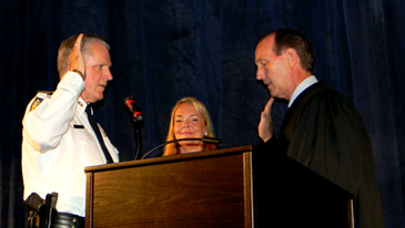 New Chief Deputy Richard Baumy, with his wife, Kim next to him, is sworn in by Justice John Weimer. 