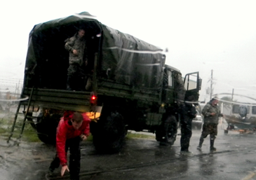 Military trucks prepare to take out Plaquemines Parish residents who were rescued from their homes by St. Bernard sheriff's deputies and others after a breach in the  Caernarvon Canal levee.