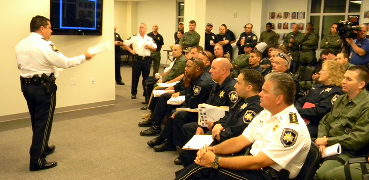 Chad Clark briefs officers involved in the operation before they set out to look for the drug suspects.