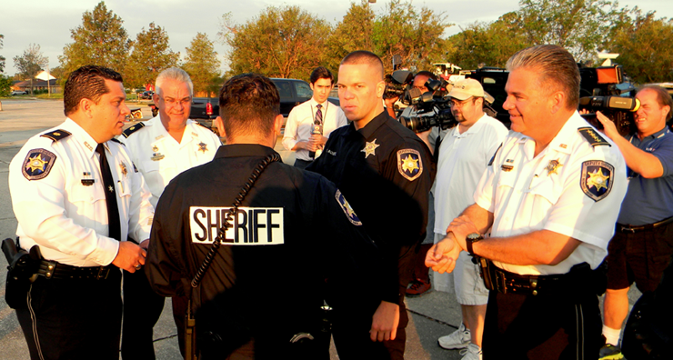 Sheriff James Pohlmann, at right, Maj. Chad Clark, at left, discuss the drug round-up at a staging area. With them are from left, Maj. Mark poche, Cp;. Daniel Bostic and, Narcotics Agent Jason Saltalmachia. 