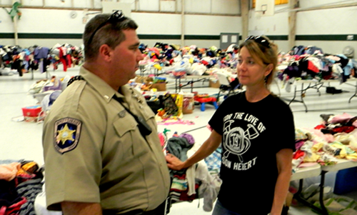 St. Bernard Sheriff’s Cpl. Shane Lulei and Suzanne Shaffer, who heads the effort by the Team Braithwaite Foundation to collect and distribute donated goods for victims of Hurricane Isaac flooding, discusses a burglary and theft of $15,000 in goods discovered on Sunday. Behind them are other donated items not stolen.