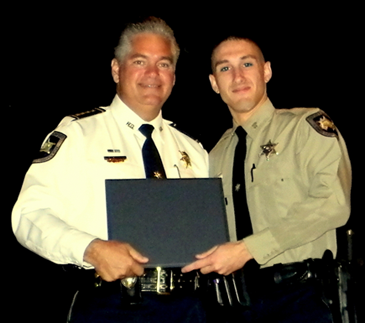 Sheriff Pohlmann on stage with Deputy Skyler Rauch.