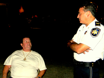 Col. John Doran talks with Allen Bienvenu, a guest at a Night Out party. 