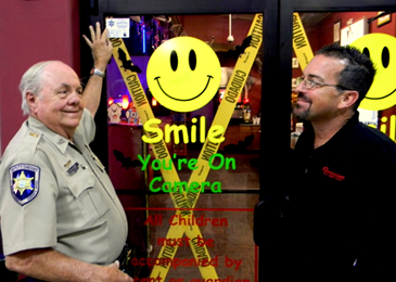 Lt. Billy Cure updates a Sheriff’s Business watch I.D. decal at the business Celebration Fun-Games-Pizza at 8700 West Jufge Perez Drive in Chalmette. With his at right is Michael McNicol, assistant manager. 