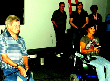  Members of the class of the sheriff’s Citizens Police Academy Christine Foret, at right, and Jimmy Beeson, both of Chalmette, hold non-firing guns as they  prepare to watch a video in a firearms simulator program which calls for them to make a split-second decision on whether to shoot a criminal suspect.