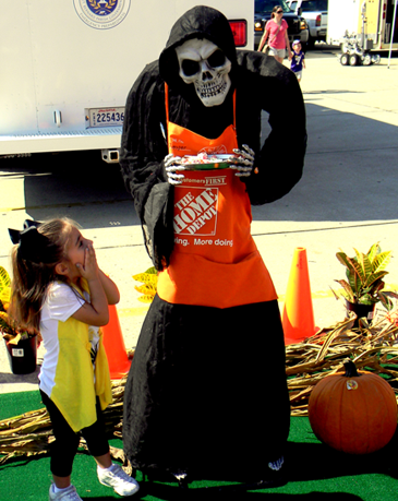 Ava Westerfield reacts to a skelton dressed in a Home Depot apron.