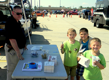 Capt. Bret Bowen with children who just received Junior Deputy pins and other items.