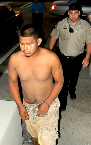 Jorge Ramirez, 17, arrested in killing of one man and injuring of another, walks into the St. Bernard Sheriff’s Detective offices Tuesday night, trailed by Sheriff’s Deputy Henry Senez. Oct. 2. S