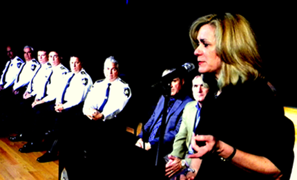 Darlene Cusanza, executive director of Crimestoppers in New Orleans, speaks to the graduates of Citizens Police Academy as Sheriff James Pohlmann and his senior staff members are seated on stage at Nunex College.