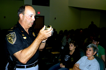 Capt. Charles Borchers looks at a lock he recommends to the class at a "Refuse to be a Victim'' seminar earlier this year.