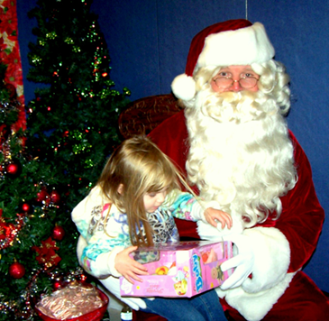 A child looks at the present she received from Santa at the 2011 Santa on the Bayou celebration being held this year on Saturday, Dec. 15 from 11 a.m. to 2 p.m. at St. Bernard Catholic Church in eastern St. Bernard. 