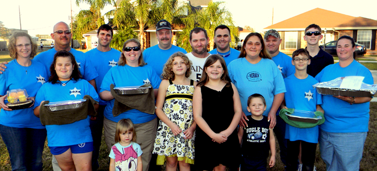 Delivering a meal to theTompkins family were, from left in front, Kaya Penton and Jayden Penton, daughters of Lt. Jamie Penton; Capt. Angela Peraza, recipients from the Tompkins family Brianna Tompkins, Jasmine Tompkins and Jared Tompkins, their mother Jennifer Tompkins; Seth Penton and his mother, Lt. Jamie Penton; Back row, Jodi Mowers of the Sheriff's Office, Col. David Mowers, Lt. Justin Meyers, Maj. Kevin Sensebe, recipent Archie Tompkins, Cpl. Jeff Babin, Capt. Adrian Chalona and his son, Jerry Weiser.