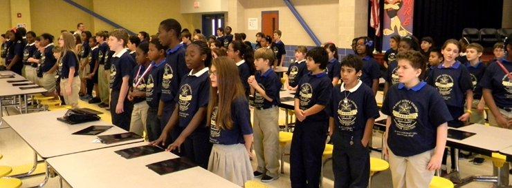 Chalmette Elementary students stand to perform the D.A.R.E. song
