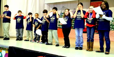 Arabi students stand to sing the D.A.R.E. song in the closing ceremony.    