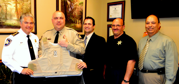 Scott Bowles, a St. Bernard Reserve Division officer and employee of Airgas Inc., holds up the protecive body armor vest the company donated to the Sheriff's Office on behalf of Bowles. At left is Sheriff James Pohlmann. Others shown are Mike Davis, general manager of the Airgas division in Harvey, Capt. Joe Ricca, the ranking officer in the Reserve Division, and Capt. Charles Borchers, who heads the Reserve Division as part of his duties as director of community relations for the Sheriff's Office which includes overseeing Neighborhood Watch and other programs. St. Bernard Parish residents who would like to apply for the Reserve Division can call Borchers at (504) 278-7628.