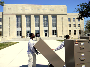 Employees of a moving company unload office files to bring into the St. Bernard Parish Courthouse, which reopens Monday.
