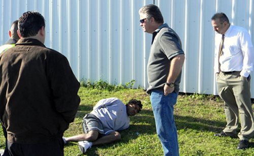The suspect, Johnson, is shown on the ground at the scene, with Sheriff Pohlmann immediately above him. At right is Det. Capt. Mark Jackson and from left are Sheriff's Deputy Gary Noriea, who made the initial traffic stop of the suuspect, and Col. John Doran, head of Operations and supervises all enforcement personnel. 