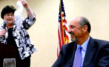 Schools Superintendent Doris Voitier, in a light-hearted moment, returns to Sheriff Stephens a pair of clean socks she said he gaver her in the aftermath of Hurricane Katrina. 	