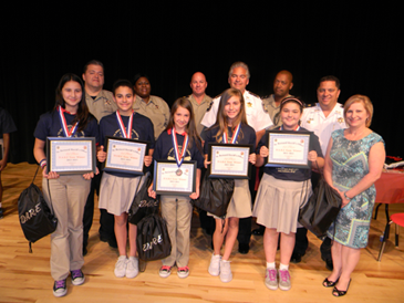 D.A.R.E. essay winners at Lacoste Elementary were Angela Romero-Barron, Kieran Marshall, Taylor Meyer, Logan Dusang and Victoria Pecunia and with them are Lacoste Principal Stacie Alfonso. In the back row are D.A.R.E. instructors Sgt. Darrin Miller, Lt. Lisa Jackson and Capt. Ronnie Martin, Sheriff James Pohlmann, Lt. Richard Jackson and Maj. Chad Clark. 