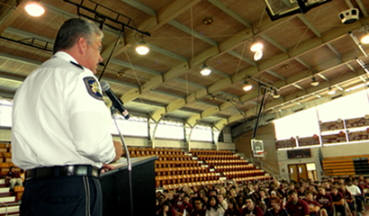 Sheriff James Pohlmann addresses Chalmette High seniors at their graduation rehersal in the former gym. 