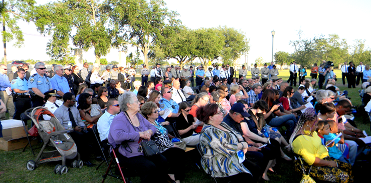 Hundreds of survivors of officers whose names were added to the memorial and current law enforcement officers surround a stage for the ceremonies at Lake Lawn cemeteries. 