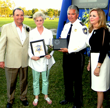 Samuel D. Gowland Jr., left, grandson of the slain deputy sheriff, and his wife, Diane, receive a remembrance of the officer. With them are Sheriff Pohlmann and Melanie Cannatella, executive director of the Louisiana Law enforcement Officers Memorial. 