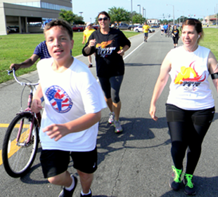 Participants approach the end of the Torch Run, back to the Arc center in Chalmette.