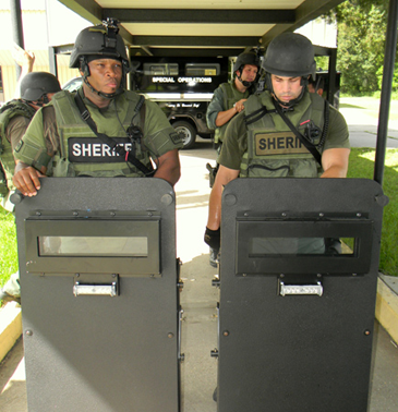 Det. Sgt. Donald Johnson, left, and Dep. Sheriff Jason Spadoni are about to bring mobile shields into the school for use in the training.