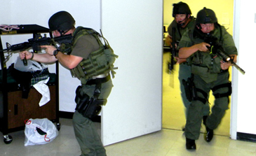 Officers burst into a room to check it during an exercise.