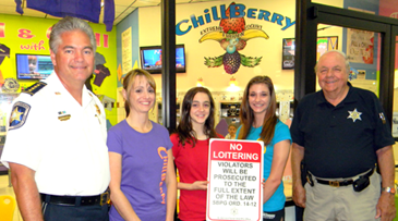 Sheriff James Pohlmann and the owner and staff of a Chalmette business, Chill Berry in the Chalmette Cinema Mall, are shown with the new No Loitering signs the Sheriff's Offics is making available to business operators, who can call 278-7628 if they want one. Shown from left are the sheriff, Dawn Menesses who with her husband Ralph Menesses owns Chill Berry, store workers holding the sign Dakota Menesses and Sabrina Minter, and Lt. Billy Cure of the sheriff's Business watch program.