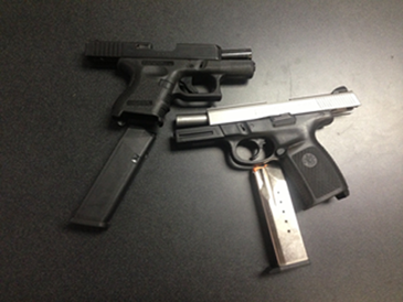 The two semi-automatic handguns recovered in the arrests.