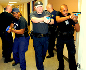 Sheriff's deputies, from left, Debrecca Richard, Joseph Warren and Timothy Williams advance in a hallway during active-shooter training, as two other officers, Capt. Ronald Martin and Sgt. Chris Scheeler, protect the rear.