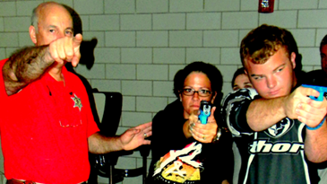 Assistant Training Director Lt. Raymond Theriot points as Dep. Sheriff Nicole Miller, left, and Reserve Division Dep. Matthew White prepare to advance into an area.