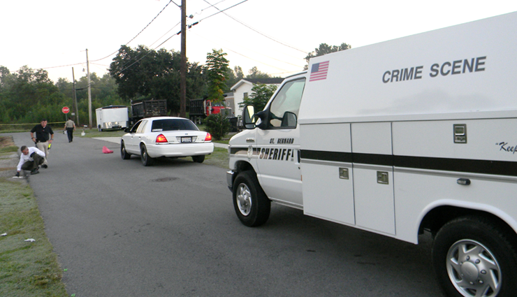 Sheriff's detectives working at the scene near where the a man's body was found in Violet early Friday.