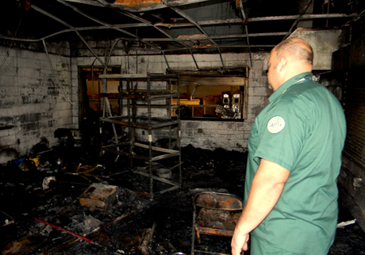 Duane Hollinsworth, one of the owners of a Chalmette business destroyed in an early morning fire on Monday, inside the room where the fire started. The business, Victory Lane hobby shop, is leased from parish government and operates in the old Vista playground gym.