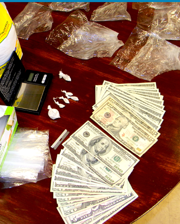 The quarter-ounce of heroin, drug paraphernalia and cash recovered in the arrest.