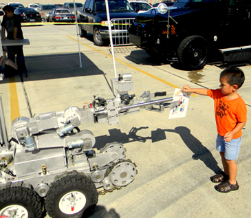 A shadow is cast as a child touches the Sheriff's Office robot at the 2012 Kids Safety Day at Home Depot in Chalmette, which is being held this year on Saturday, Oct. 5 from 10 a.m. to 2 p.m. 