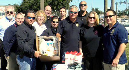 Maj. Chad Clark and Sheriff James Pohlmann hold up one of the boxes containing medications turned in at the Prescription Drug Take-Back Day held Oct. 26 at the Walgreens store in Chalmette. Walgreens officials and law enforcement officers are also shown. On the right in front is Warren Rivera, Assistant Special Agent in Charge of the New Orleans field division for the federal Drug Enforcement Administration, and to his right is his wife, Cheryl Rivera of the FBI. In the middle row, from left, is Chris Lafitte of Walgreens, Capt. Pat Childress and Cpl. Jessica Gernados of the Sheriff's Office. In back, from left, are Walgreens officials Bob Lips, Dustin Mares, James Woringen Jr. and Gerard Robinette.