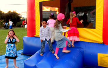 Children prepare to enter a bounce tent at a party in Chalmette.