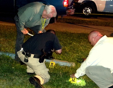 heriff's detectives, from left, Sgt. Steve Guillot, Sgt. Jeff Vega and Sgt. Paul Miller use flashlights to help search for shells at the scene of the murder of a man in Violet Tuesday night in the 3100 block of Daniel Drive.