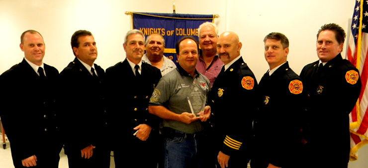 Firefighter oif the Year was Deputy Chief Glenn Ellis. Shown from left are firefighters Engineer Clinton Melerine, Capt. Troy Serigne, District Chief Gerald Carlini, Grand Knight Cisco Gonzales giving the award to Ellis, Fire Prevention Officer Charles Licciardi and Dist. Chief Joseph Dullary. In back are Council Chairman Al Graffia and Program Director Fred Billiot, 