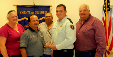 Chad Singletary of Acadian Ambulance was Paramedic of the Year. He is shown receiving the award from Grand Knight Cisco Gonzales. Also shown are Janie Fuller of Acadian, Council Chairman Al Graffia and Program director Fred Billiot.