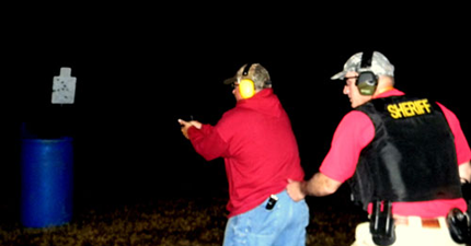 Capt. Brian Clark advances on targets in the dark, with Lt. Raymond Theriot behind him.