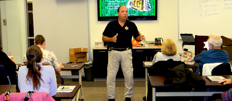 Capt, Charles Borchers addresses about 25 parish residents who attended the lecture called Refuse to be a Victim, which discussed crime prevention strategies,