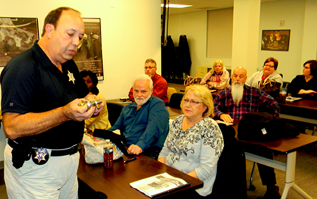 Capt, Charles Borchers demonstrates a lock to the audience, which he said was good for residences.