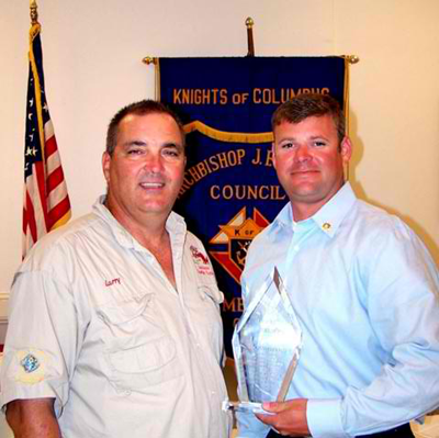 Lt. Brent Bourgeois, right, receives the Knights of Columbus St. Bernard Deputy of the Year Award from Larry Gonzales, left, Grand Knight of the Knights of Columbus Rummel Council 5747 in Chalmette. 