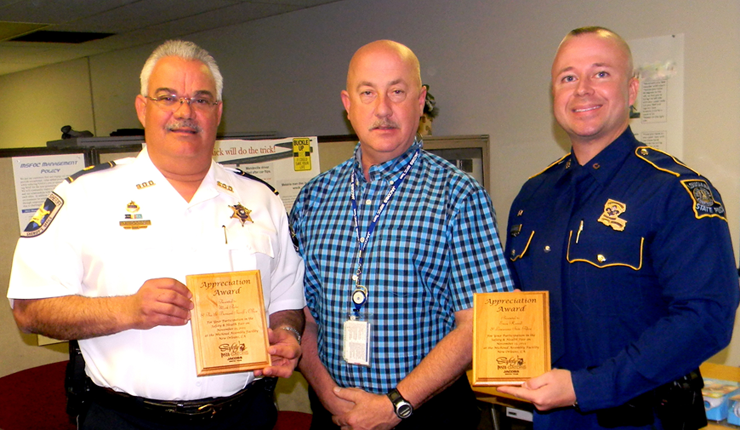 Steve Hanberg of Jacobs Technology, center, presented plaques to Maj. Mark Poche, left. and Trooper Evan Harrell for the Sheriff's Office and State Police's participation in a Nov. 13 Safety and Health Fair at Michoud. 