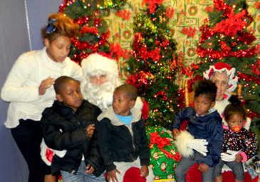 With Santa and Mrs. Claus at the Santa on the Bayou Celebration are Jaquanna Sylve, standing; Mrs. Claus, portrayed by Philomene Serigne, who is holding Jayden Sylve and Jaqua Sylve; and Santa, portrayed by Frank Gioe; holding Jaylon Sylve and Jayni Sylve.